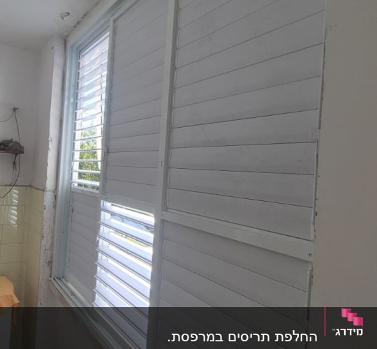 תריסי אלומיניום מותקנים על חלון פנימי